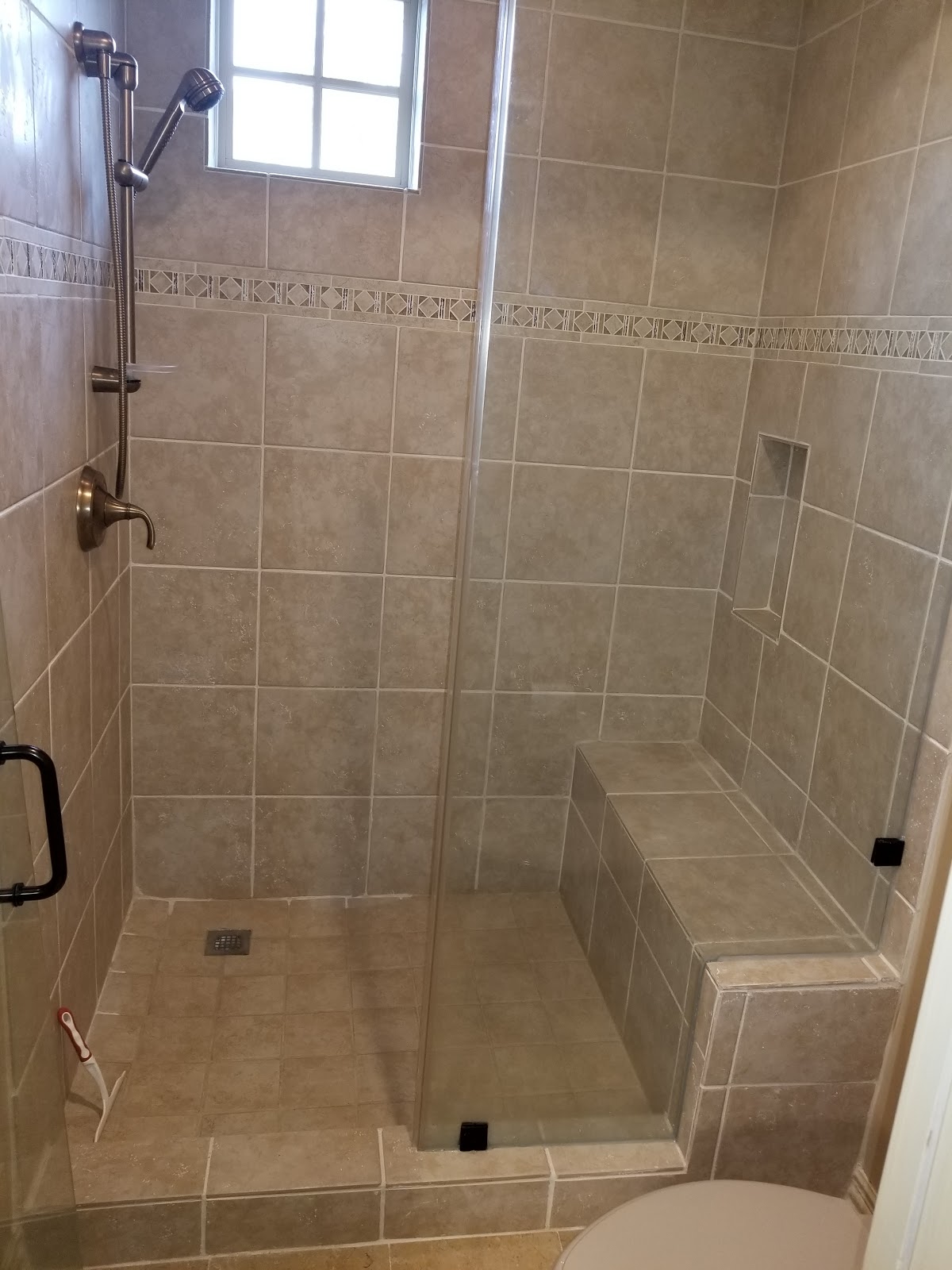 Walk-in shower with floor-to-ceiling tile